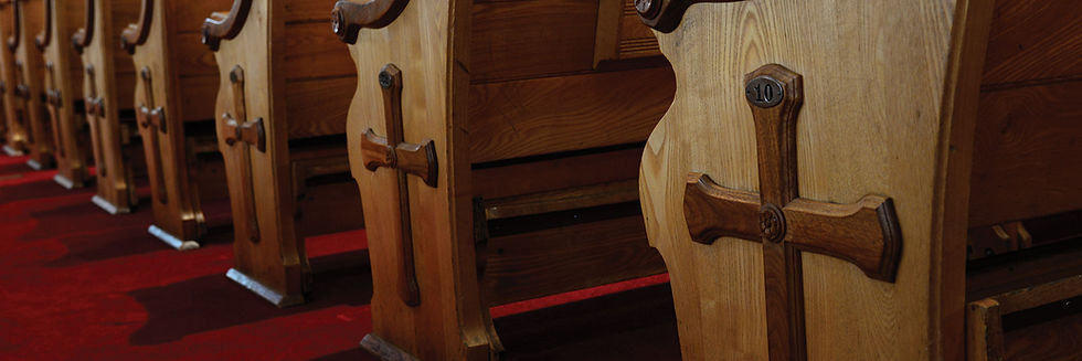 A church with wooden pews and classic lighting